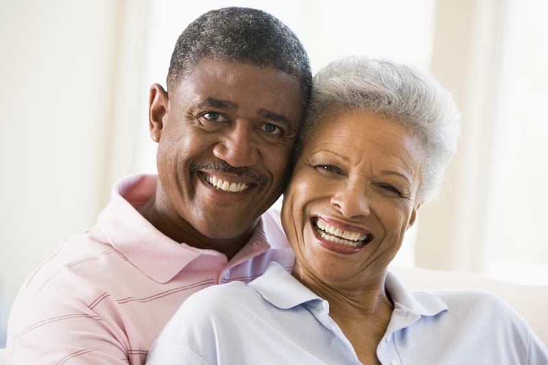 Older couple smiling and sitting together